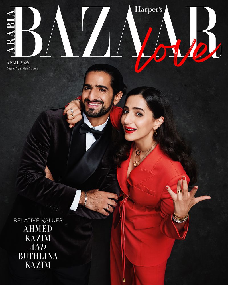 Magazine cover featuring a smiling adult male in a tuxedo and a smiling adult female in a red suit against a dark background.
