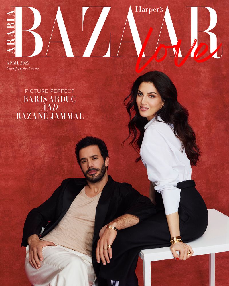 Magazine cover features a man in black and a woman in white seated together against a red background, with the Harper's Bazaar logo at the top.
