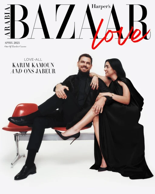 Harper's Bazaar Arabia cover featuring a man and woman in all-black attire, posed on a red bench against a stark white background.