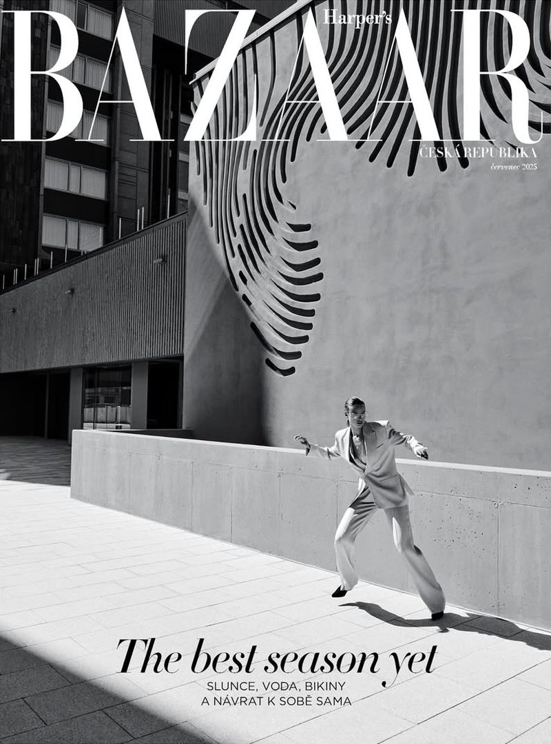 Harper's Bazaar cover in black and white featuring a posed adult male in suit against an urban backdrop with architectural details.