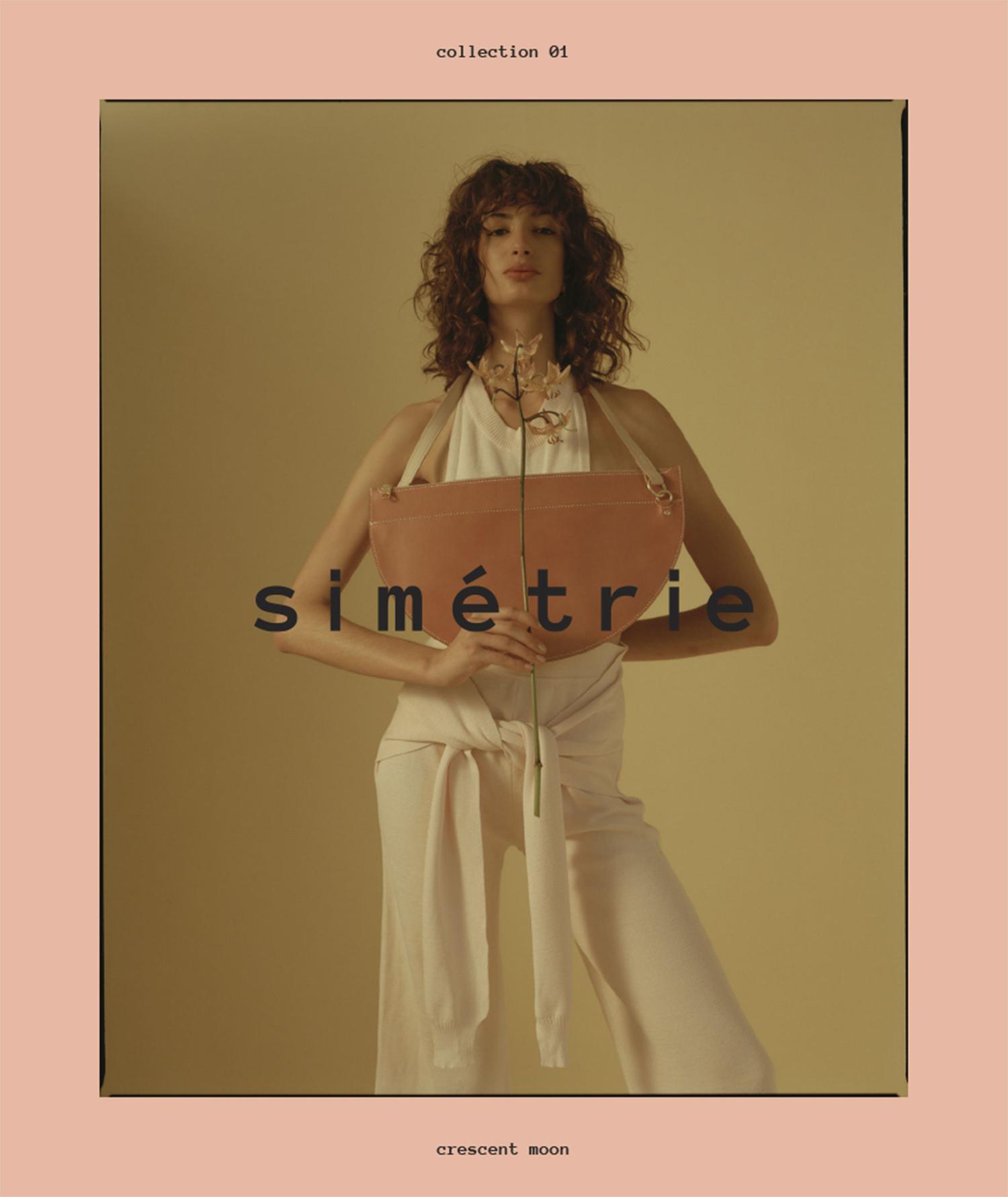 A stylish woman in a cream-colored outfit poses with a handbag in a studio setting, complemented by soft lighting and muted tones for fashion.