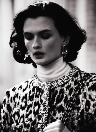 Lara Mullen wearing a leopard print tweed jacket and white turtleneck in a black and white fashion portrait.