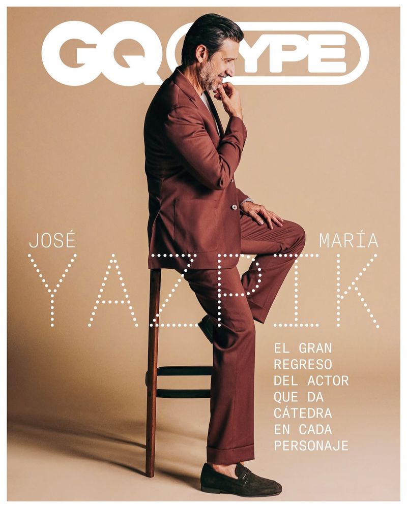 Magazine cover features a man in a suit sitting on a stool against a beige background with large typography and the GQ Type logo.
