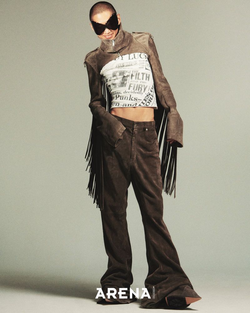 Model Bojvck Kang in a brown fringed suede jacket, graphic crop top, and sculptural sunglasses for Arena Homme+ Korea editorial.