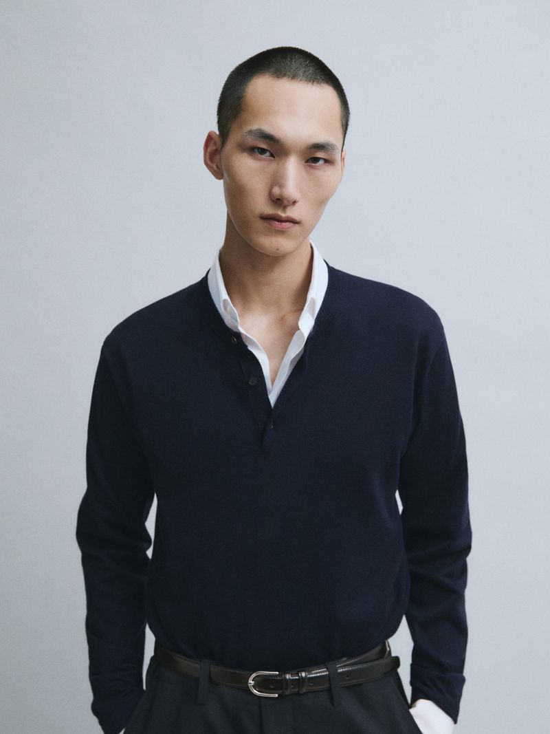 Model Siquan Wang wearing a navy knit polo over an open white shirt against a neutral backdrop for Massimo Dutti.