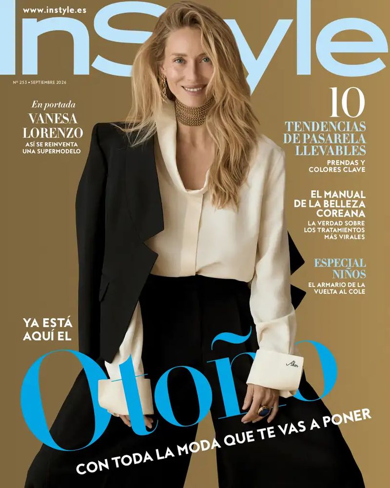 Model Vanesa Lorenzo on the InStyle Spain cover wearing a cream silk blouse and black blazer against a solid tan background.