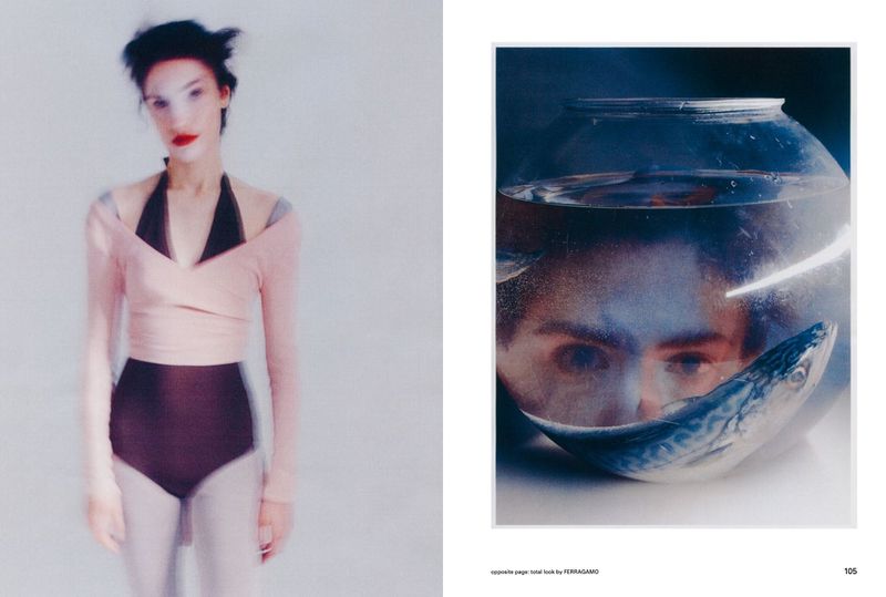 Fashion editorial image featuring a blurred female model in pink top and dark bottoms next to an eye staring from a fishbowl.