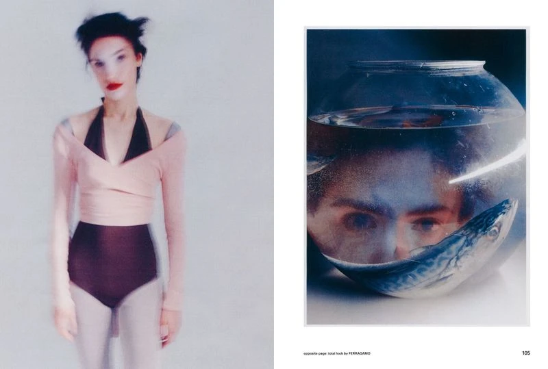 Fashion editorial image featuring a blurred female model in pink top and dark bottoms next to an eye staring from a fishbowl.