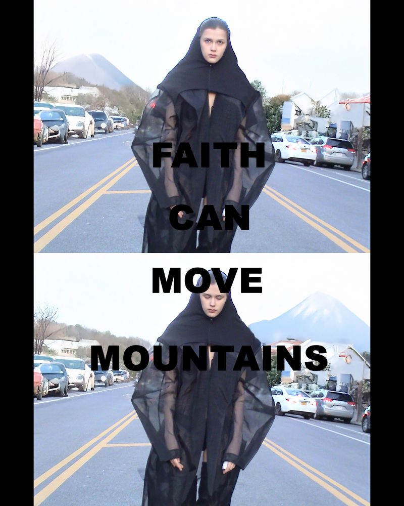 Woman in black hooded robe stands on a road, with a mountain backdrop and text overlay reading 'Faith can move mountains.'