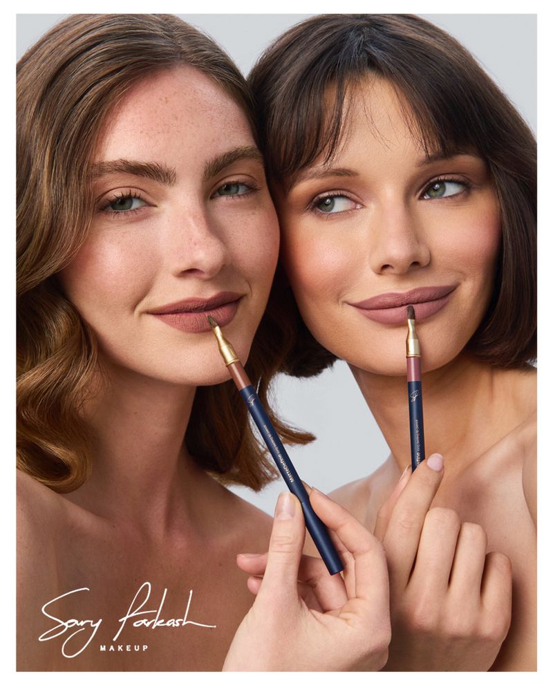 Two women showcasing matte lip shades while holding lip liner pencils to their lips against a light grey studio background.