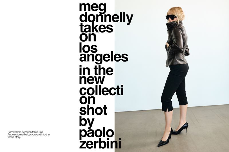 Meg Donnelly wearing a dark leather jacket, cropped black pants, and pointed high heels beside bold typography on a white studio backdrop.