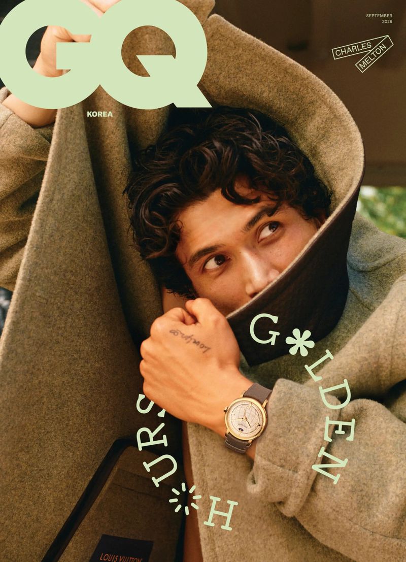Charles Melton bundled inside an oversized textured wool coat wearing a luxury wristwatch on the cover of GQ Korea.
