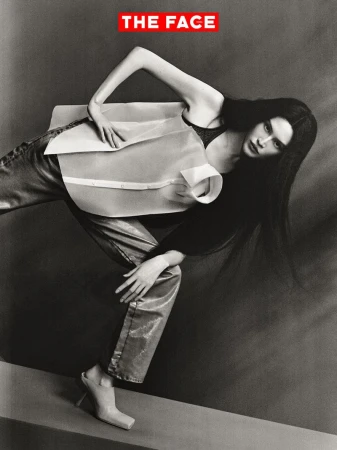 Model Sui He in a structured white top and metallic trousers striking a dynamic pose against a studio backdrop for The Face China.