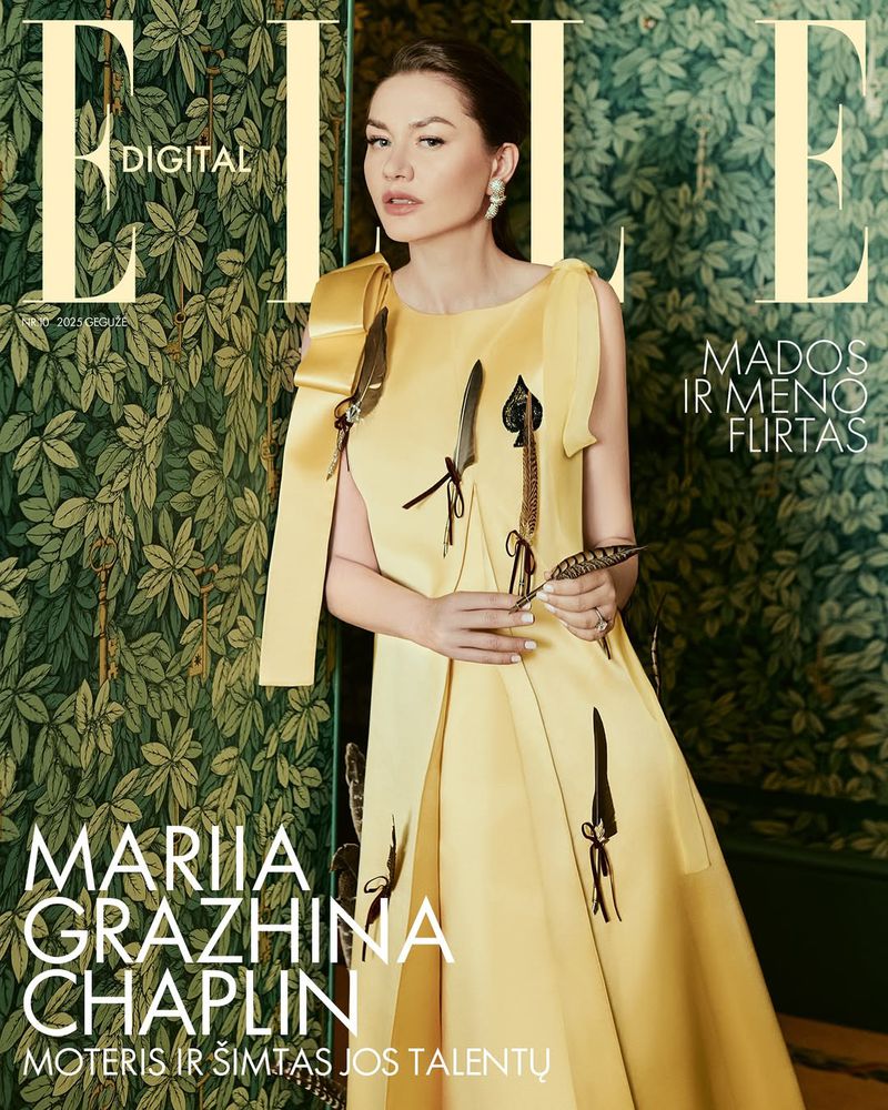 Elle magazine cover featuring a woman in a yellow dress with feather accents, posing against a backdrop of green foliage.