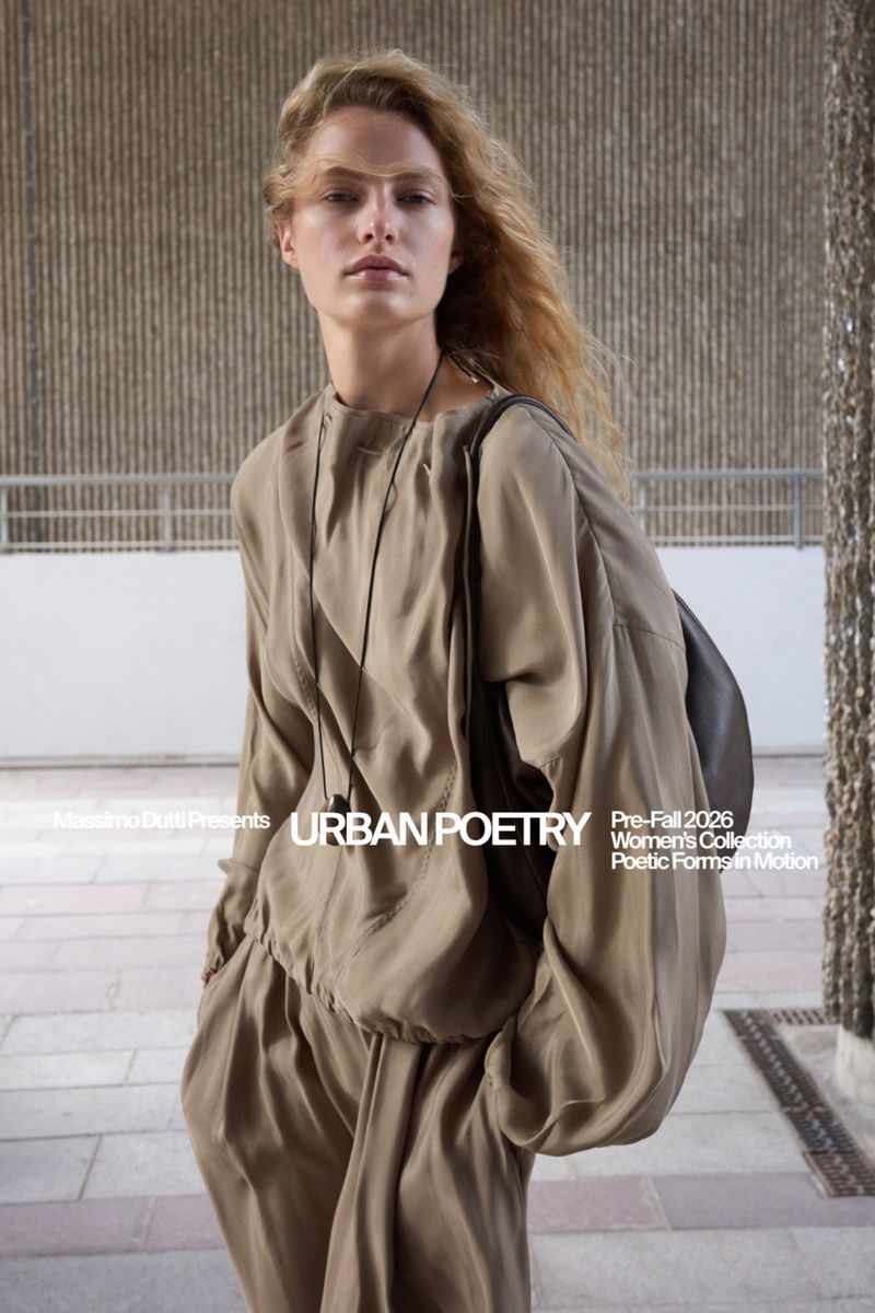 Felice Nova Noordhoff posing in a loose taupe silk blouse and matching trousers on an outdoor terrace for Massimo Dutti.