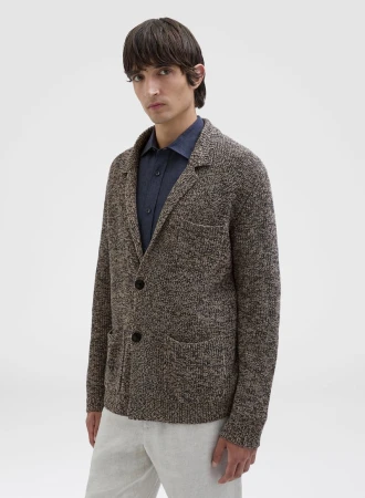 Model wearing a textured brown knit cardigan and dark shirt against a seamless white background for Agnona.