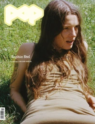 Pop Magazine cover featuring Sophia Stel lying in a grassy meadow in an olive sleeveless dress, photographed by Gillian Garcia.