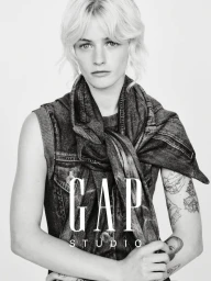 Esther Rose McGregor wearing an acid wash denim vest and draped denim wrap against a white studio background for Gap Studio.