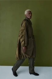 Amanda Parker walking in an oversized olive green quilted parka coat and matching trousers for Marfa Stance Autumn/Winter 26.