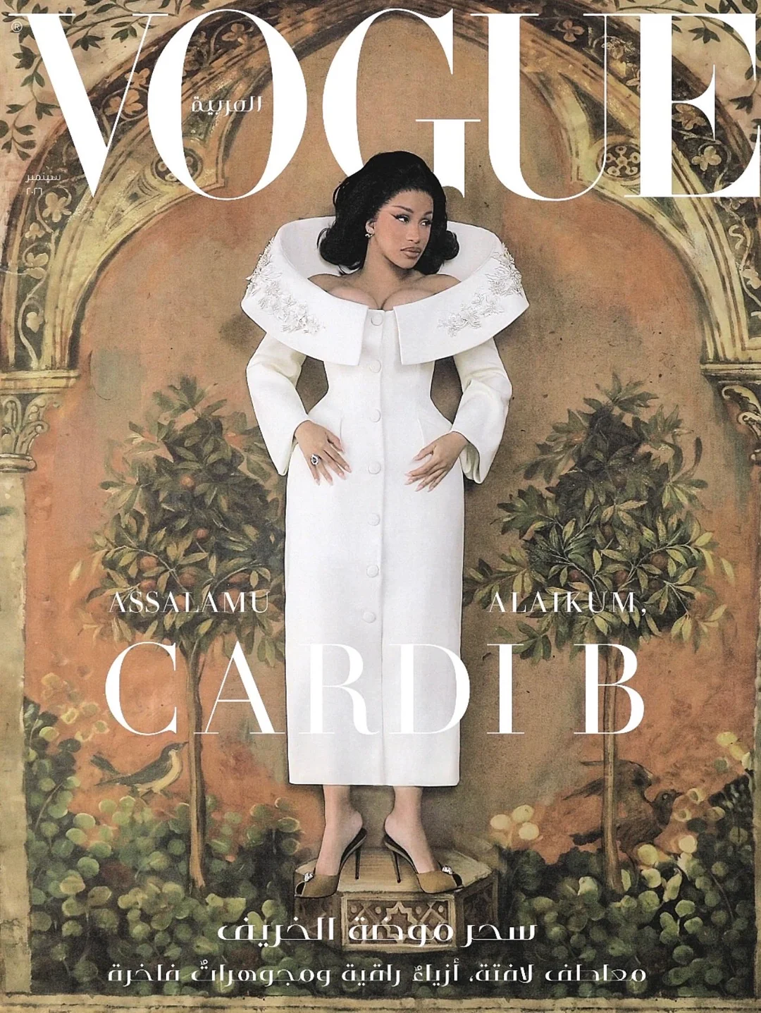 Cardi B wearing a sculptural white gown with an exaggerated wide collar standing in front of an illustrated backdrop for Vogue Arabia.