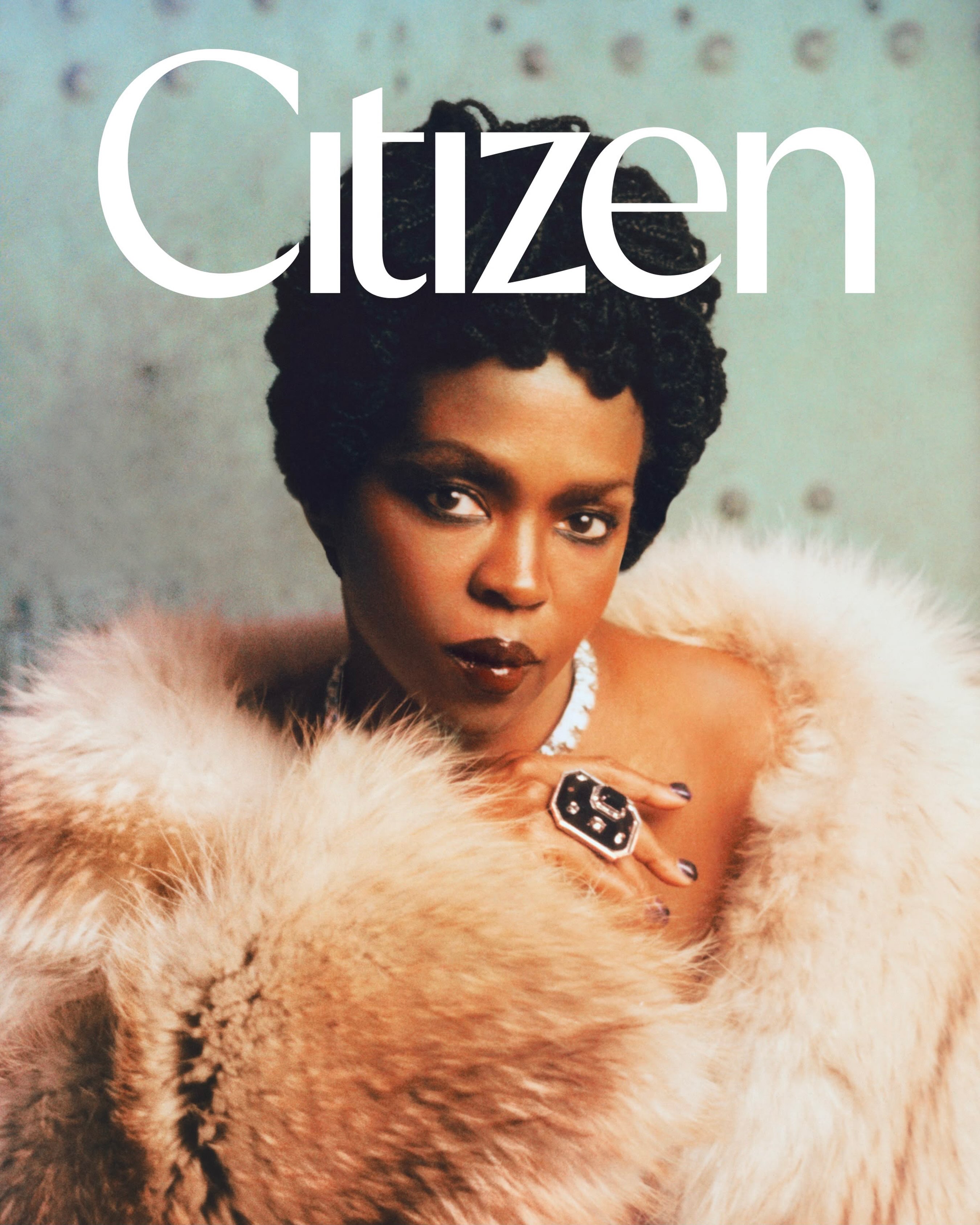Ms. Lauryn Hill wearing a plush beige fur coat and statement jewelry on the cover of Citizen Magazine.