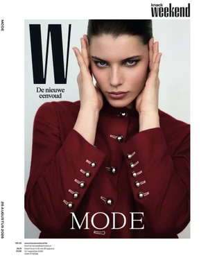 Model Mirthe Dijk poses in a burgundy buttoned jacket with hands on her face for the Knack Weekend magazine cover.