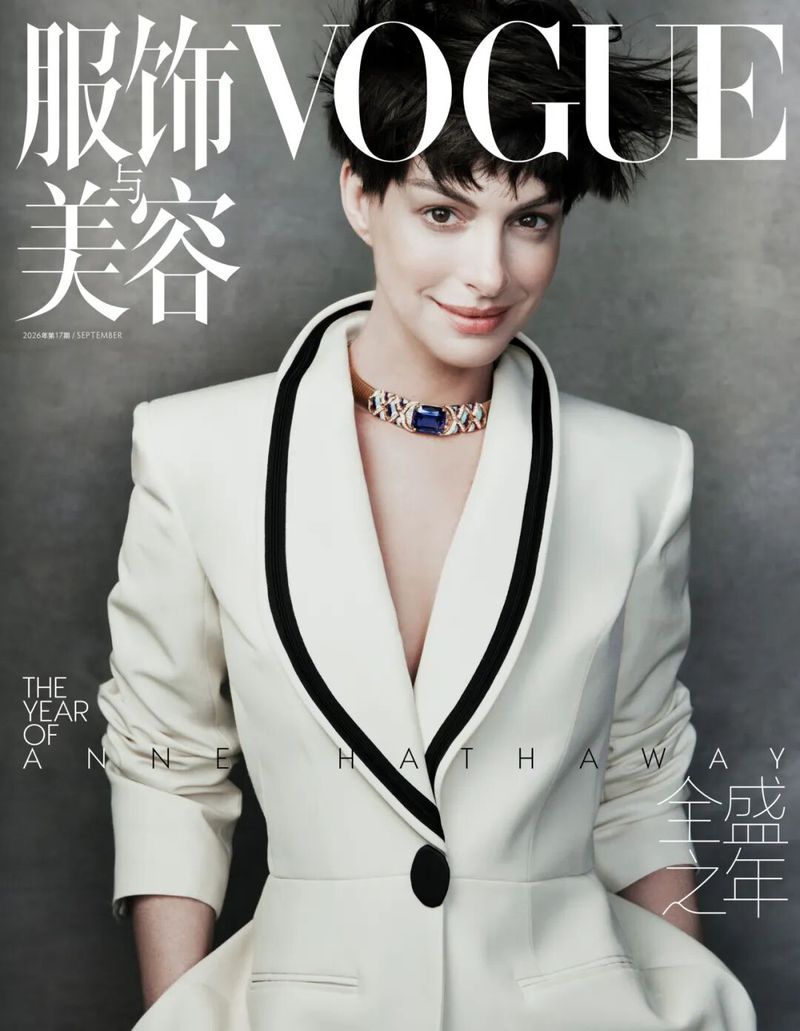 Anne Hathaway on the Vogue China cover wearing an off-white blazer with black piping, a gemstone choker, and a textured pixie cut.
