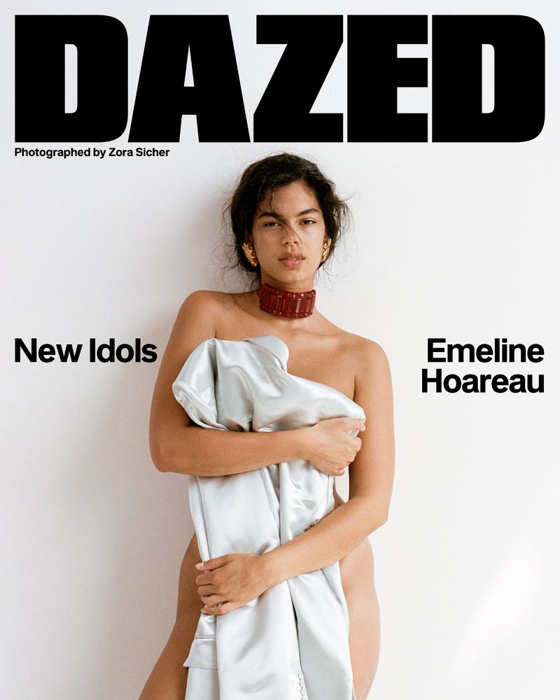Emeline Hoareau holding a draped silver fabric against a plain white background for the cover of Dazed Magazine.