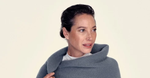 Christy Turlington wearing a grey woolen wrap and white top against a neutral background for Giorgio Armani