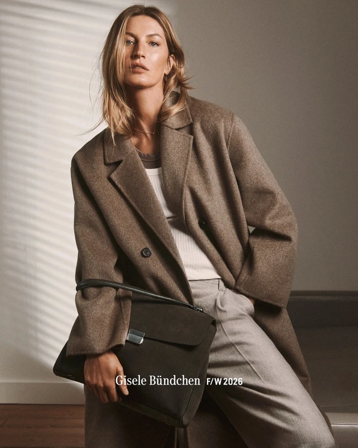 Gisele Bündchen wearing a brown coat and holding a dark handbag in an editorial campaign for Marc O'Polo