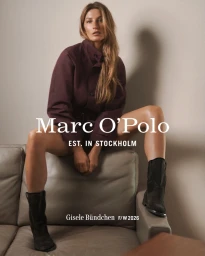 Gisele Bundchen seated on a leather sofa wearing a plum jacket and black boots for Marc O'Polo