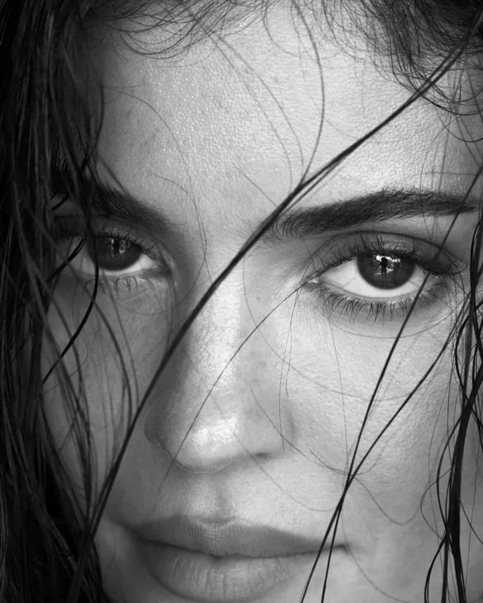 Close-up black and white portrait of Kylie Jenner with wet hair framing her face for Alo by Mert and Marcus.