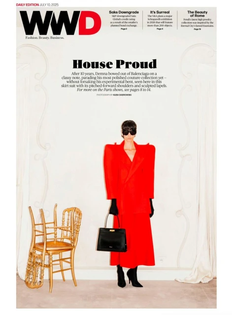 WWD cover featuring a full-length shot of a person in a red skirt suit, styled with black accessories, standing next to a golden chair.