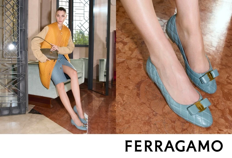Vittoria Ceretti seated in a coat and quilted blue flats holding a handbag for Salvatore Ferragamo Fall-Winter 2026 campaign.