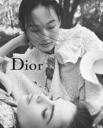 Black and white portrait of models in textured textured jackets outdoors with Dior typography overlay