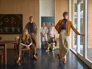 Group of six models posing in a modern interior setting wearing Loro Piana apparel for Fall-Winter 2026