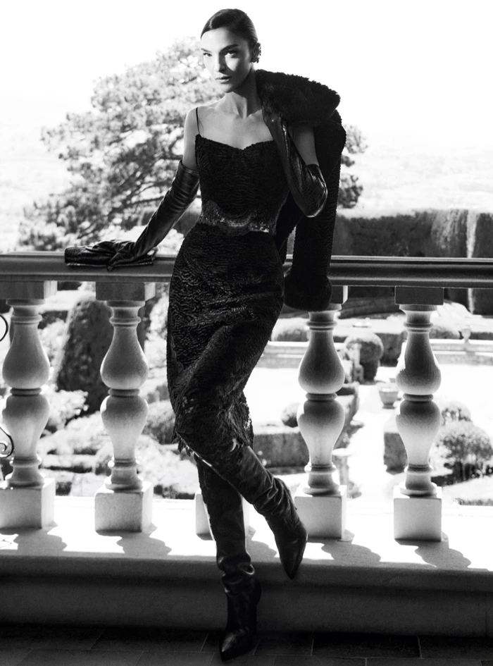 Model Mariacarla Boscono in black dress and opera gloves leaning on a balustrade for Ermanno Scervino Fall-Winter 2026 Campaign