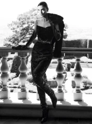 Model Mariacarla Boscono in black dress and opera gloves leaning on a balustrade for Ermanno Scervino Fall-Winter 2026 Campaign