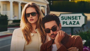 Man and woman wearing sunglasses outdoors near a Sunset Plaza sign for Oliver Peoples photographed by Aaron Feaver.