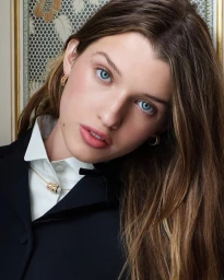 Portrait of Ever Anderson wearing a white shirt and black jacket with gold earrings and necklace for Dior My Dior campaign.