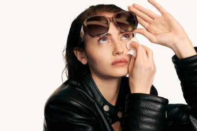 Model Leni Klum wearing a black leather jacket and sunglasses for Guess Forever campaign