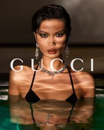 Model Tian Xi Wei wearing a black bikini and diamond necklace in a swimming pool for Gucci Monte Carlo Summer 2026 campaign.
