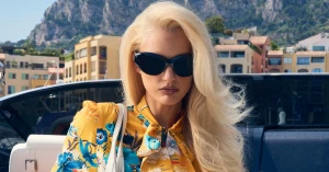 Amelia Gray wearing black sunglasses and a yellow floral top outdoors for Gucci Monte Carlo Summer 2026 campaign.