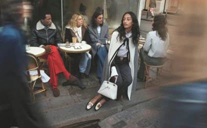 Group of models seated at sidewalk cafe tables wearing Dior apparel for Pre-Fall 2026 campaign photographed by David Sims