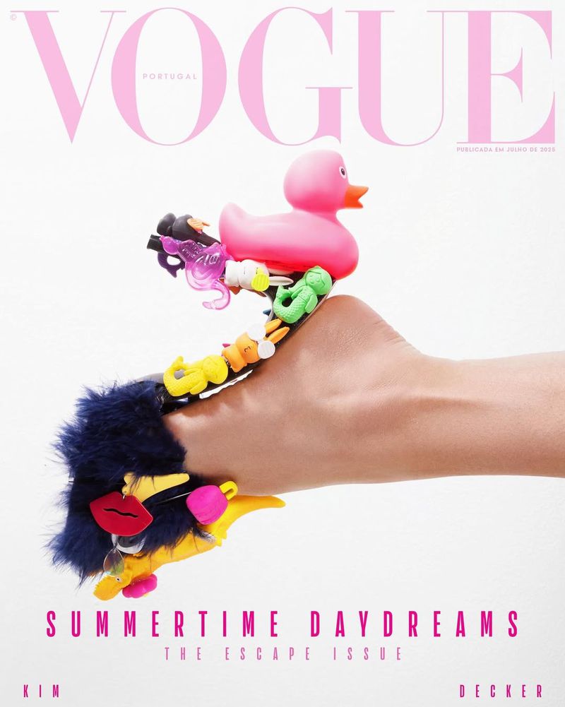 Vogue Portugal magazine cover featuring a hand adorned with colorful toys including a pink rubber ducky against a white backdrop.