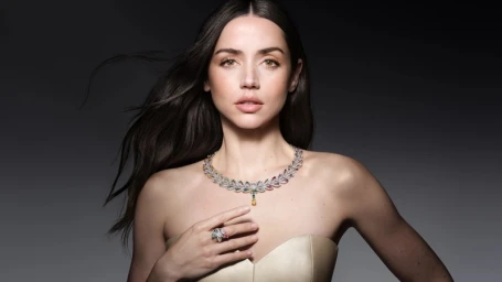 Ana de Armas wearing an intricate diamond and gemstone necklace and matching ring for Louis Vuitton Mythica project