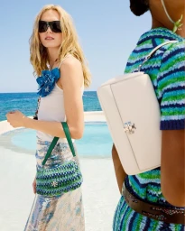 Alex Consani and Sacha Quenby wearing Tory Burch by pool with ocean view, photographed by Anthony Seklaoui.