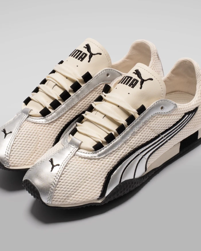 Puma H-Street ivory sneakers with silver metallic accents and black branding against a neutral grey studio background