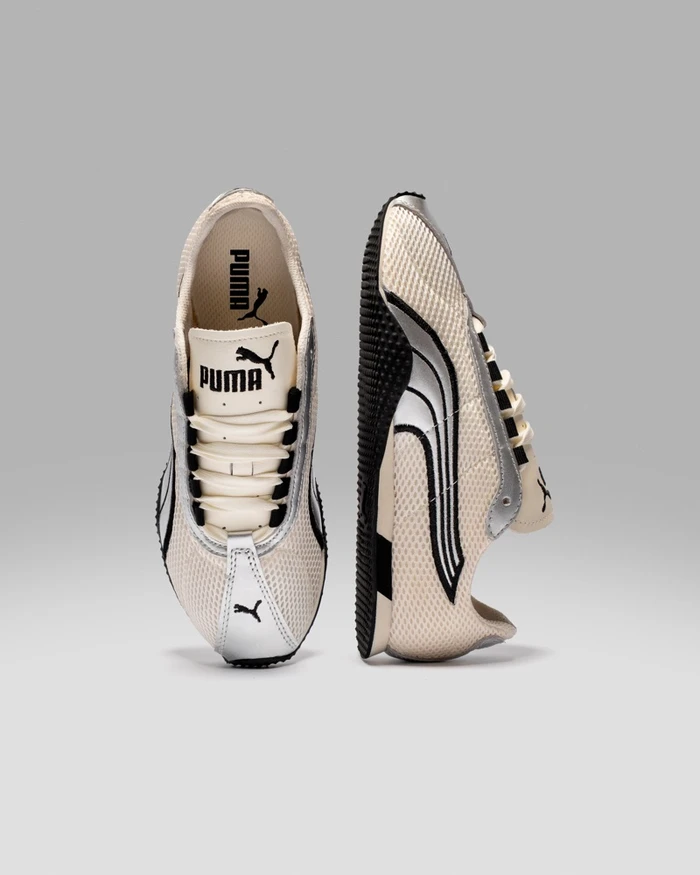 Two Puma sneakers shown in front and profile views against a seamless grey studio background