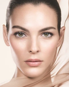 Close up beauty portrait of model Vittoria Ceretti with luminous skin and subtle neutral makeup for Giorgio Armani.